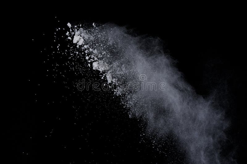White powder explosion on black background. Dust splatted isolated. Paint Holi. White powder explosion on black background. Dust splatted isolated. Paint Holi.