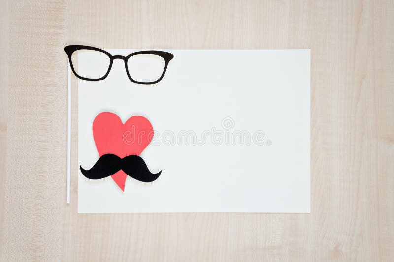 Exponeringsglas hjärta, mustasch på träbakgrund Lycklig bakgrund för dag för fader` s arkivbild Exponeringsglas hjärta, mustasch på träbakgrund Lycklig bakgrund för dag för fader` s arkivbild