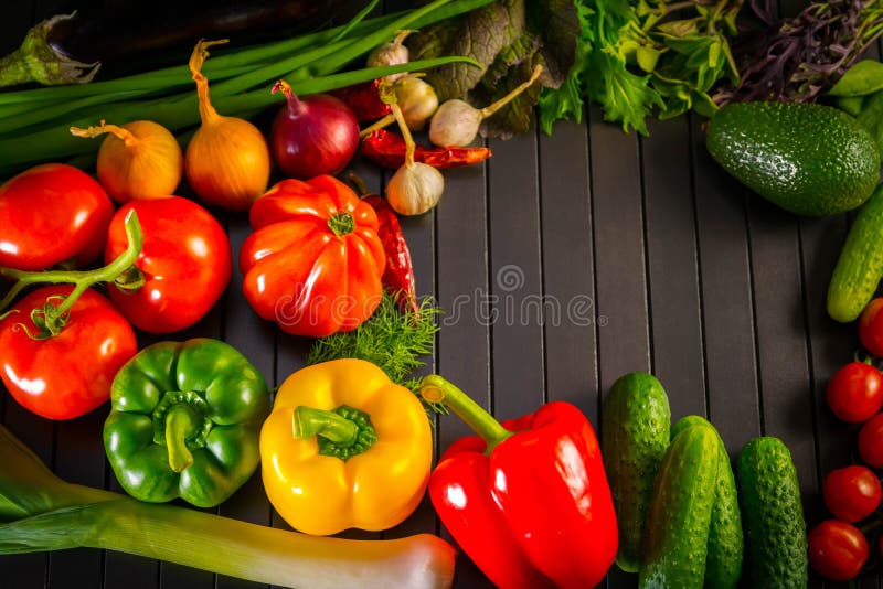 Exposition close up of fresh organic vegetables, composition with assorted raw organic vegetables, red pepper and tomato, cucumber
