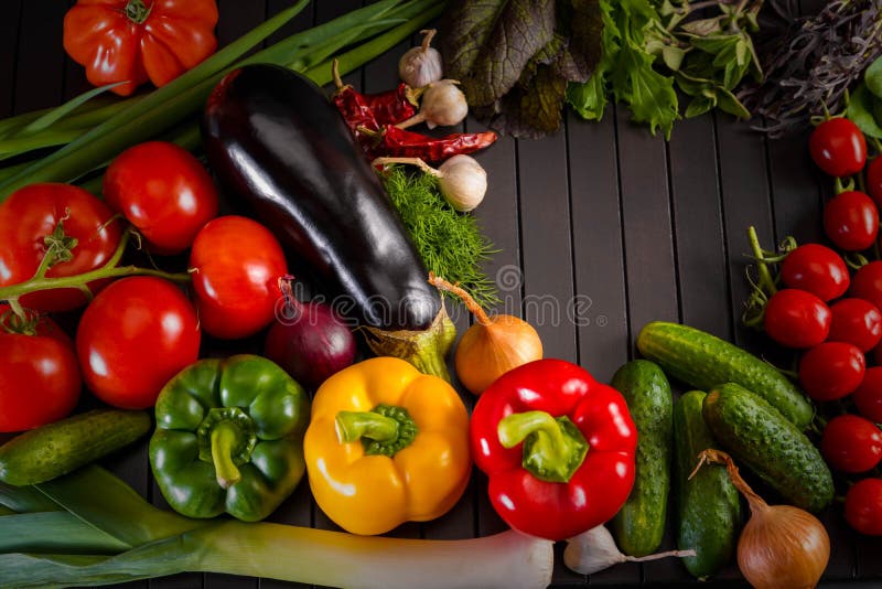 Exposition close up of fresh organic vegetables, composition with assorted raw organic vegetables, red pepper and tomato, cucumber