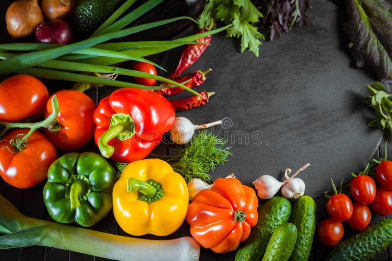 Exposition close up of fresh organic vegetables, composition with assorted raw organic vegetables, red pepper and tomato, cucumber