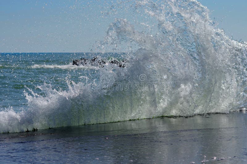 Seascape. Waves show. Summer, sea, sun, beach, holiday, fun. Curtain of water in sunlight - Black Sea, landmark attraction in Romania. Seascape. Waves show. Summer, sea, sun, beach, holiday, fun. Curtain of water in sunlight - Black Sea, landmark attraction in Romania.