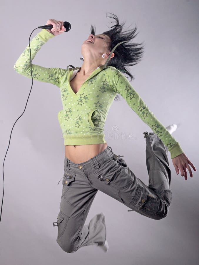 Young woman with microphone in air. Rock diva stock images, royalty-free photos and pictures