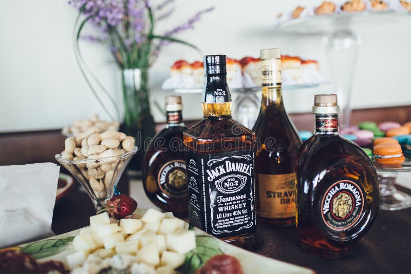 Exquisite Alcoholic Drinks and Snacks on Buffet Table Editorial
