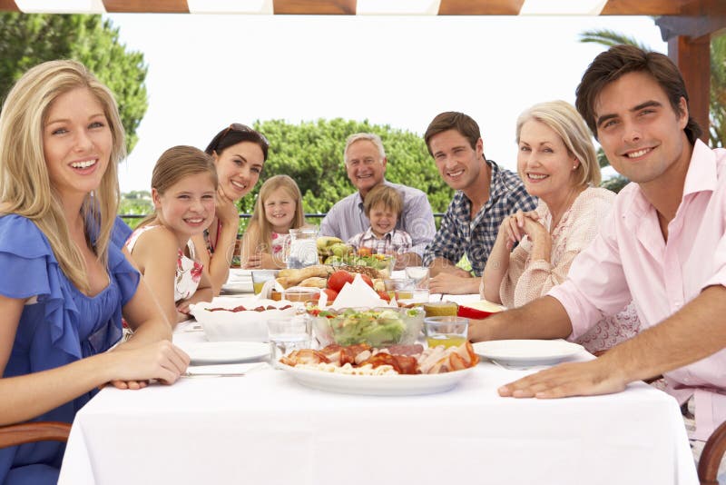 Extended Family Group Enjoying Outdoor Meal Together stock photo Extended Family Group Enjoying Outdoor Meal Together stock photo