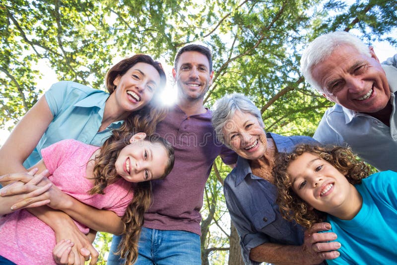 Extended family smiling in the park royalty free stock photo Extended family smiling in the park royalty free stock photo
