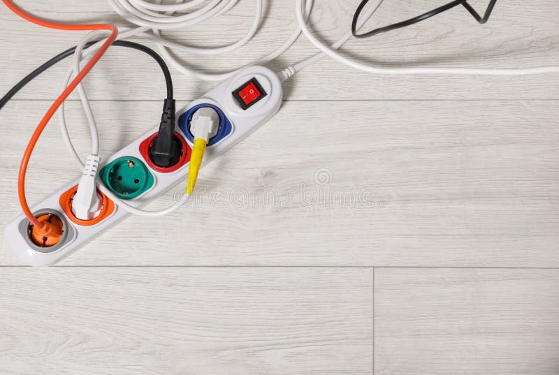 Extension cord with electrical plugs on white floor, flat lay. Space for text. Damaged extension cord stock images, royalty-free photos and pictures