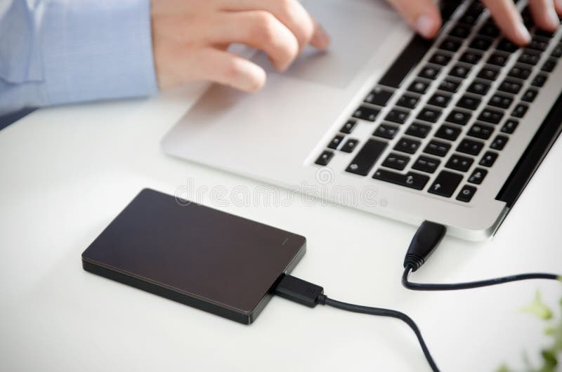 External backup disk hard drive connected to laptop