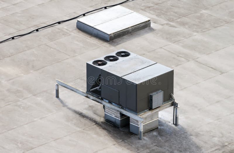 The external units of the commercial air conditioning and ventilation systems are installed on the roof of an industrial building royalty free stock photo
