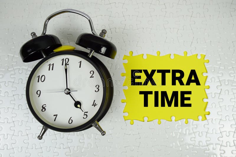 Extra time text with alarm clock on yellow background stock images