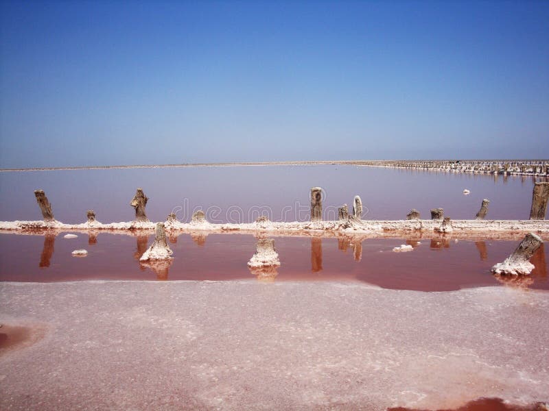 Extraction of salt in the estuary with red water. Salt pillars