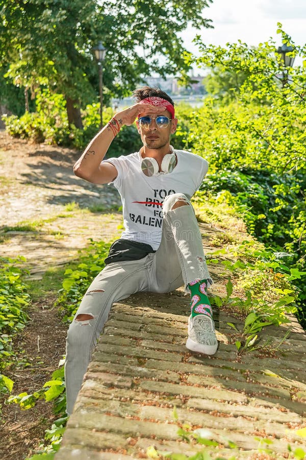 Model Posing On Nature Sitting On Stones. Photo Outdoor Stock Photo,  Picture and Royalty Free Image. Image 94920355.