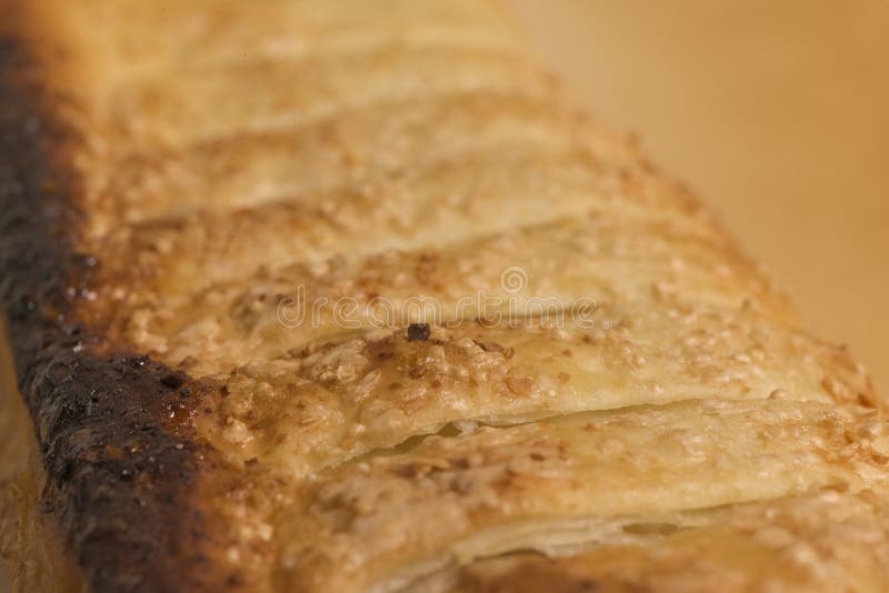 Extreme Close-Up of Apple Strudel Crust Showing Flaky Layers, Golden-Brown Edges, and Sugar Crystals in Soft Focus royalty free stock photos