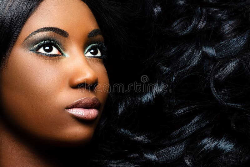 Beauty portrait of african woman with curly long hair