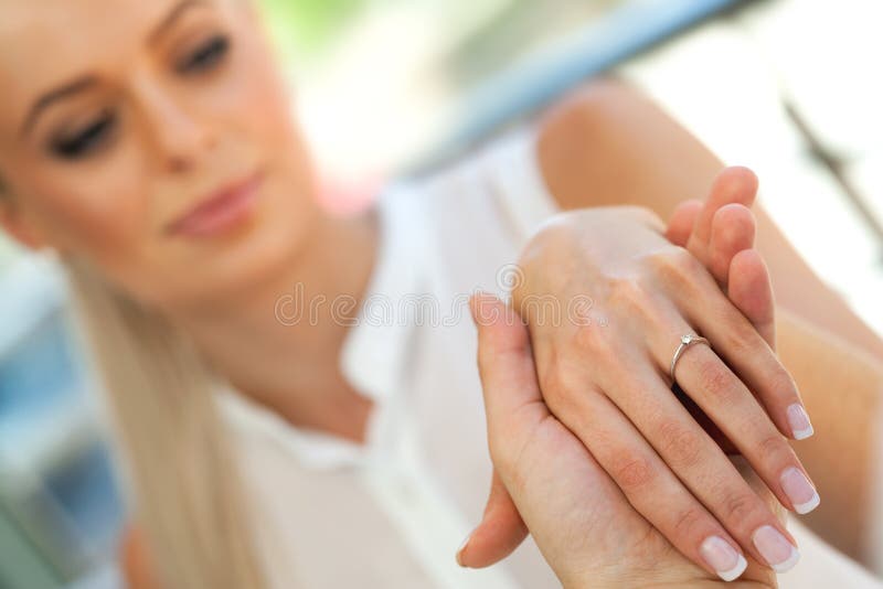 Extreme close up of girls hand with engagement ring. stock images