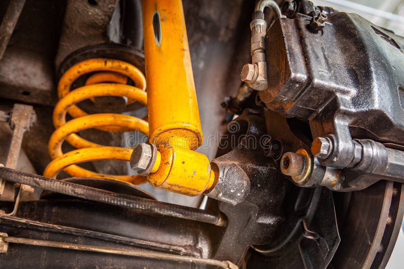 Yellow shock absorber underneath a car. royalty free stock images Yellow shock absorber underneath a car. royalty free stock images