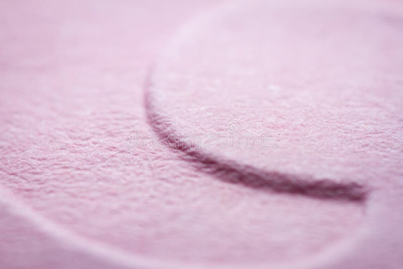 Extreme macro of embossed pink paper stock photo