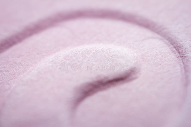 Extreme macro of embossed pink paper stock image