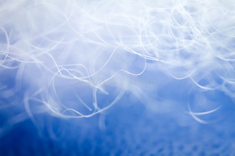 Extreme macro of polyester stable fiber on blue background stock image