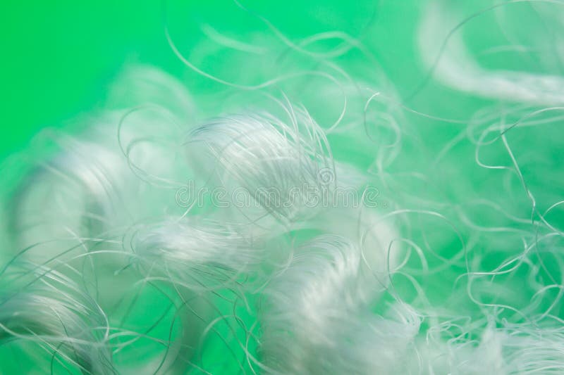 Extreme macro of polyester stable fiber on green background royalty free stock photo