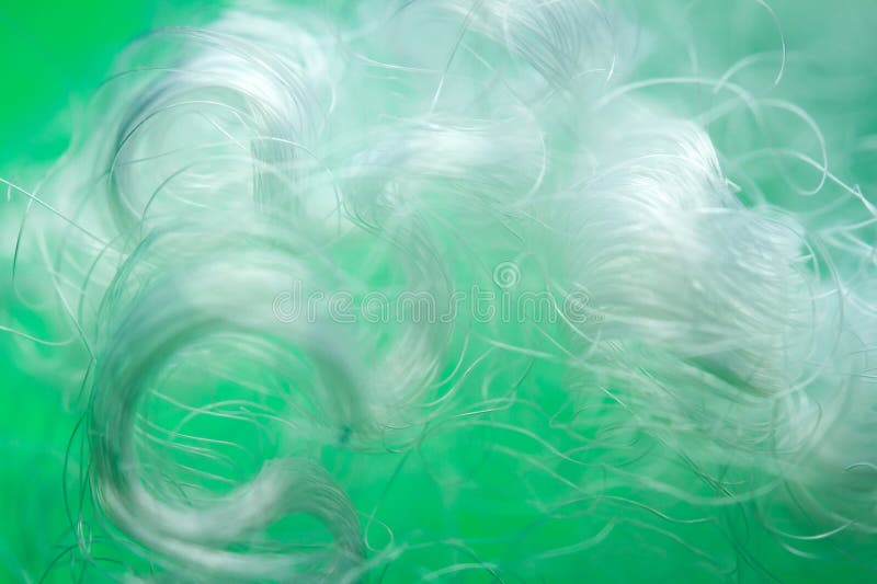 Extreme macro of polyester stable fiber on green background royalty free stock images