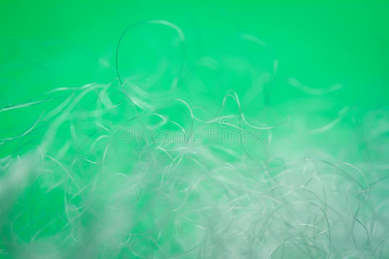 Extreme macro of polyester stable fiber on green background stock photography