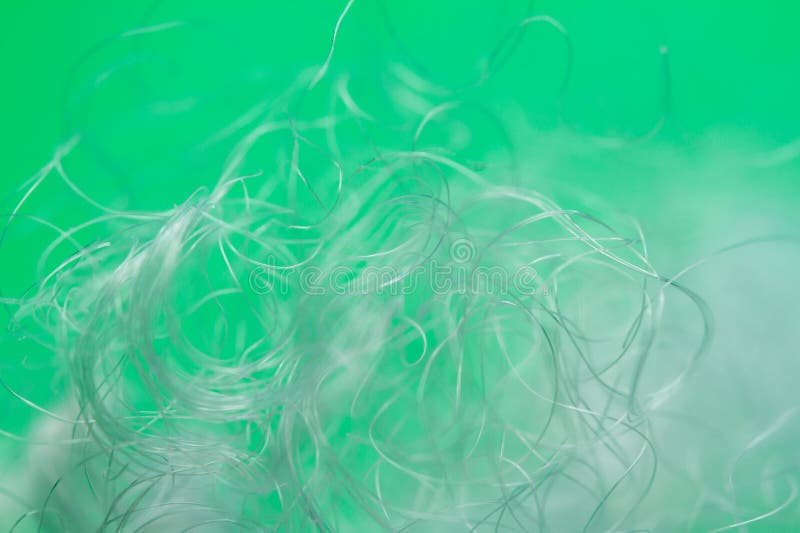 Extreme macro of polyester stable fiber on green background stock photos