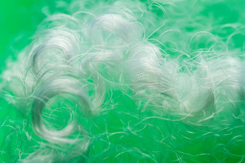 Extreme macro of polyester stable fiber on green background stock photography