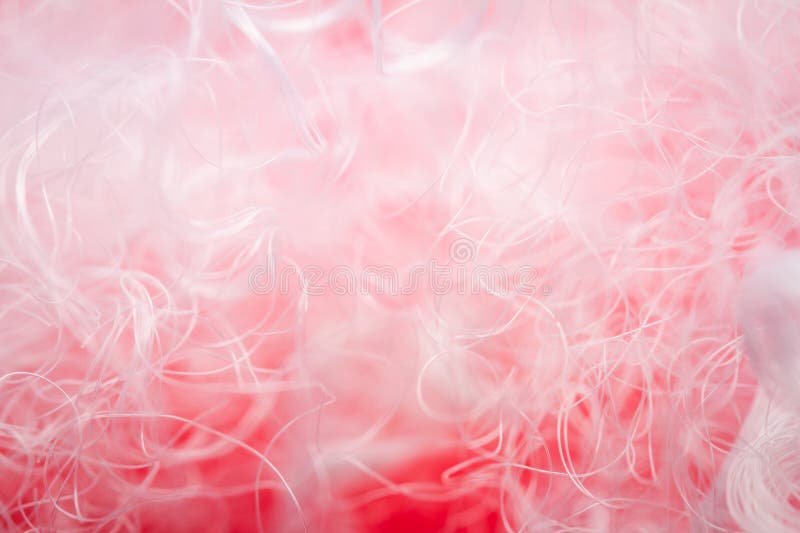 Extreme macro of polyester stable fiber on red background stock image