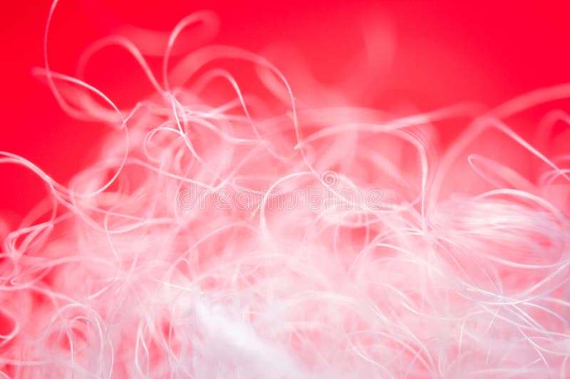 Extreme macro of polyester stable fiber on red background royalty free stock photography