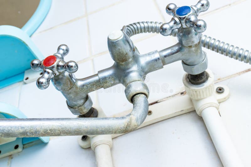 Extremely dirty water tap, old faucet with limescale and rust in bathroom, calcified detail of shower mixer tap need to be cleaned stock photos