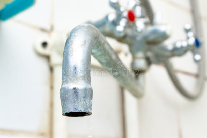 Extremely dirty water tap spout with limescale and rust close up, calcified detail of shower mixer tap need to be cleaned royalty free stock image