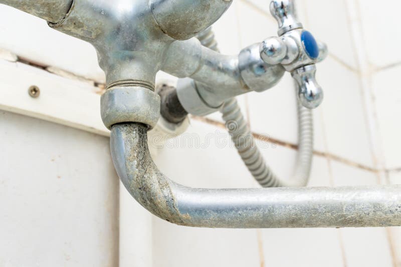 Extremely dirty water tap spout with limescale and rust close up, calcified detail of shower mixer tap need to be cleaned royalty free stock photos