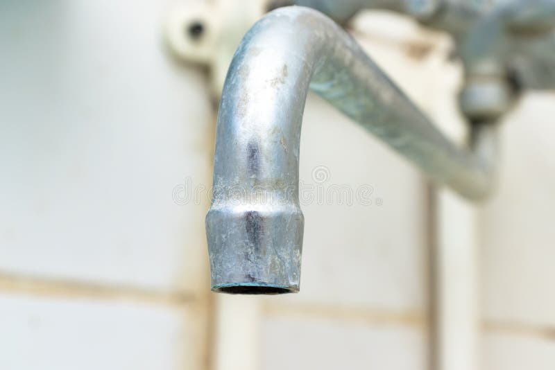 Extremely dirty water tap spout with limescale and rust close up, calcified detail of shower mixer tap need to be cleaned royalty free stock photography