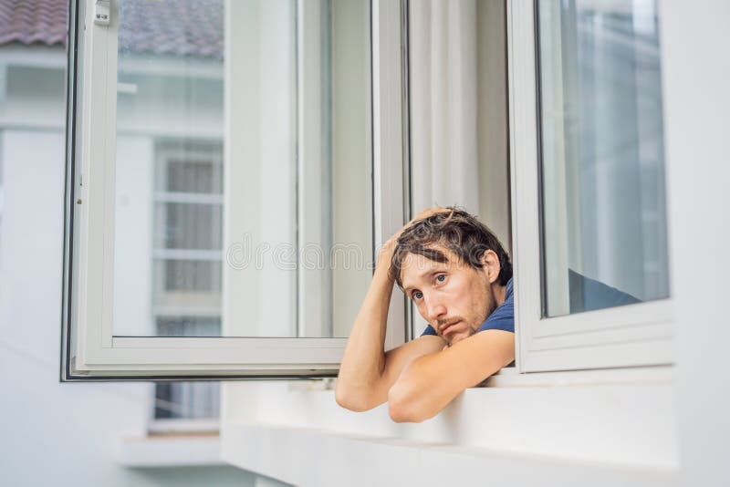 Young Man by the Window Looking Outside Stock Photo - Image of  disappointment, grief: 85427746