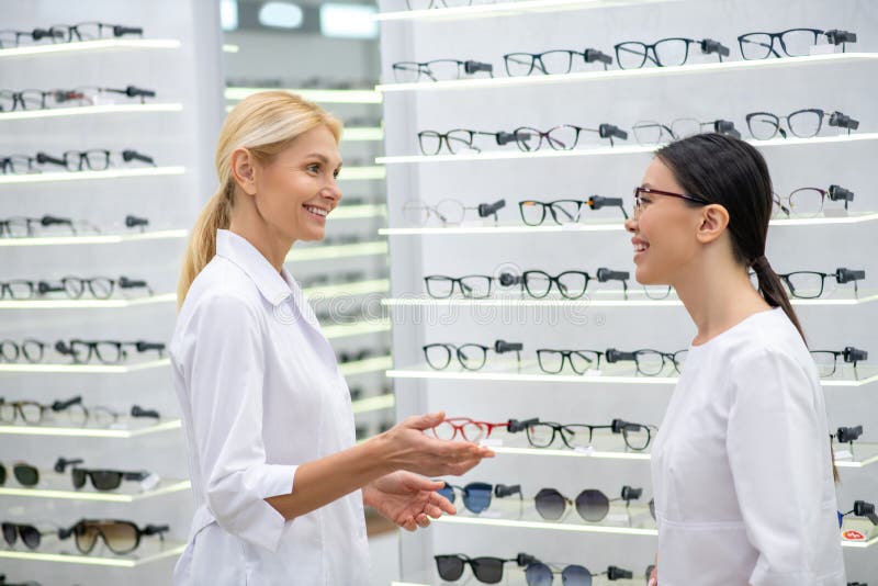 Eye Doctor Greeting Her New Assistant in the Optical Store Stock Image