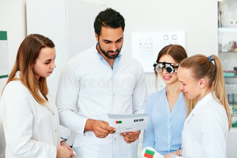 Eye Exam. Doctors Checking Woman Eyesight With Optometry Glasses royalty free stock image Eye Exam. Doctors Checking Woman Eyesight With Optometry Glasses royalty free stock image