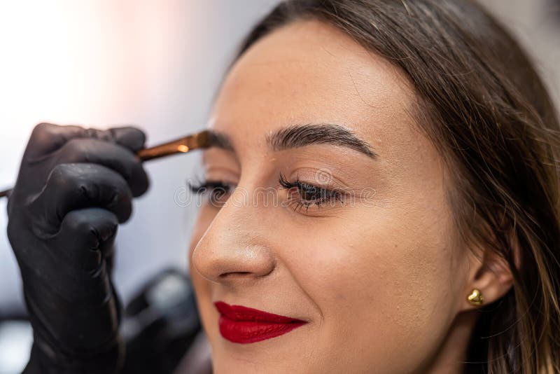 Eyebrow Correction and Modeling in a Beauty Salon Closeup. Perfect