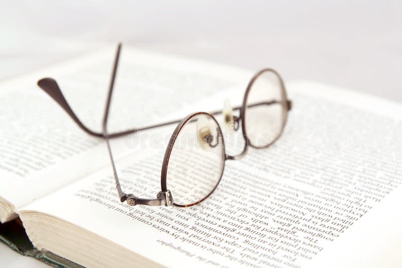 Eyeglasses on open book stock photo Eyeglasses on open book stock photo
