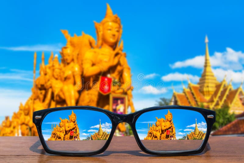 Eyeglasses on wooden table front of Thai candle festival at Ubon Ratchathani, Thailand stock photography Eyeglasses on wooden table front of Thai candle festival at Ubon Ratchathani, Thailand stock photography