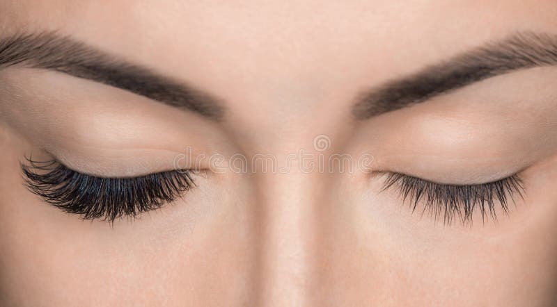 Eyelash removal procedure close up. Beautiful Woman with long lashes in a beauty salon