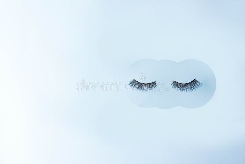 Eyelashes on blue background, copy space. concept of beauty stock photography Eyelashes on blue background, copy space. concept of beauty stock photography