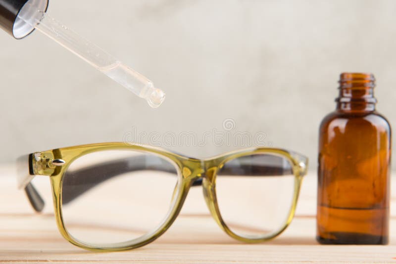 Eyesight Care Concept Eye Drops and Eyeglasses Close Up Stock Image