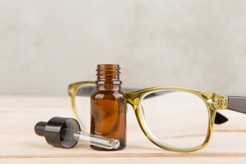 Eyesight Care Concept Eye Drops and Eyeglasses Close Up Stock Photo