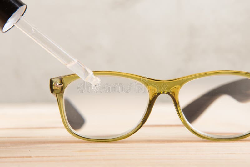 Eyesight Care Concept Eye Drops and Eyeglasses Close Up Stock Photo