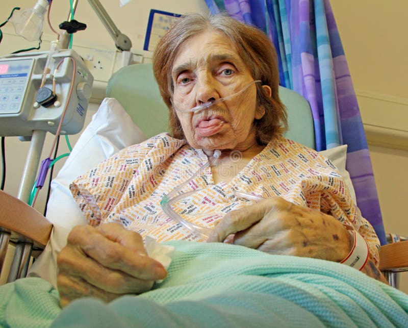 Photo of a female hospital patient on oxygen breathing equipment and feeding peg tube. Photo of a female hospital patient on oxygen breathing equipment and feeding peg tube.