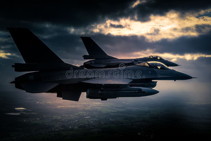 F-16 Falcon multirole fighter aircrafts maneuvering in the sky during stormy weather