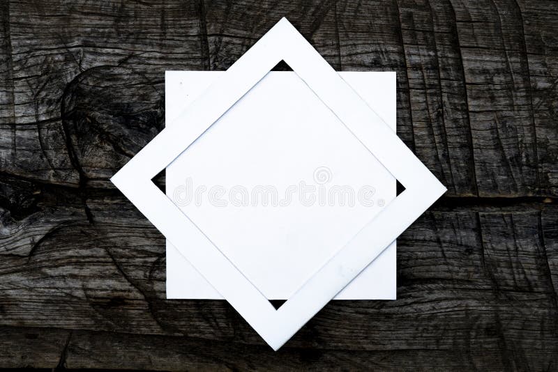F overhead top view of white square frame on top of dark wooden scratched surface mock up concept, creative layout. Concept f retro style stock images, royalty-free photos and pictures