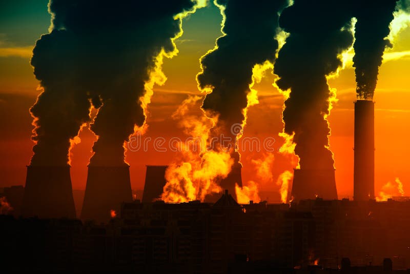 Factory of heat engineering chimney with clouds of streem in sky winter evening. Factory of heat engineering chimney with clouds of streem in sky winter evening