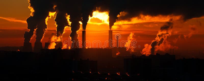 Factory of heat engineering chimney with clouds of streem in sky winter evening. Factory of heat engineering chimney with clouds of streem in sky winter evening